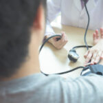 doctor-checking-patient-arterial-blood-pressure(Hypertension)